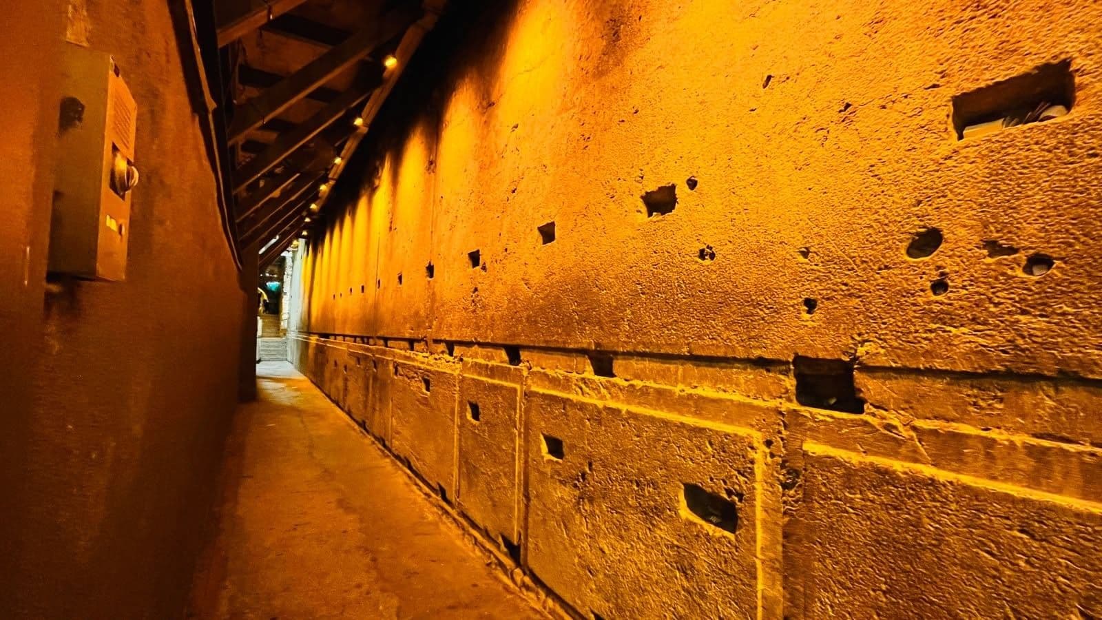 Illuminated stone blocks line a narrow passage in the Western Wall Tunnels.