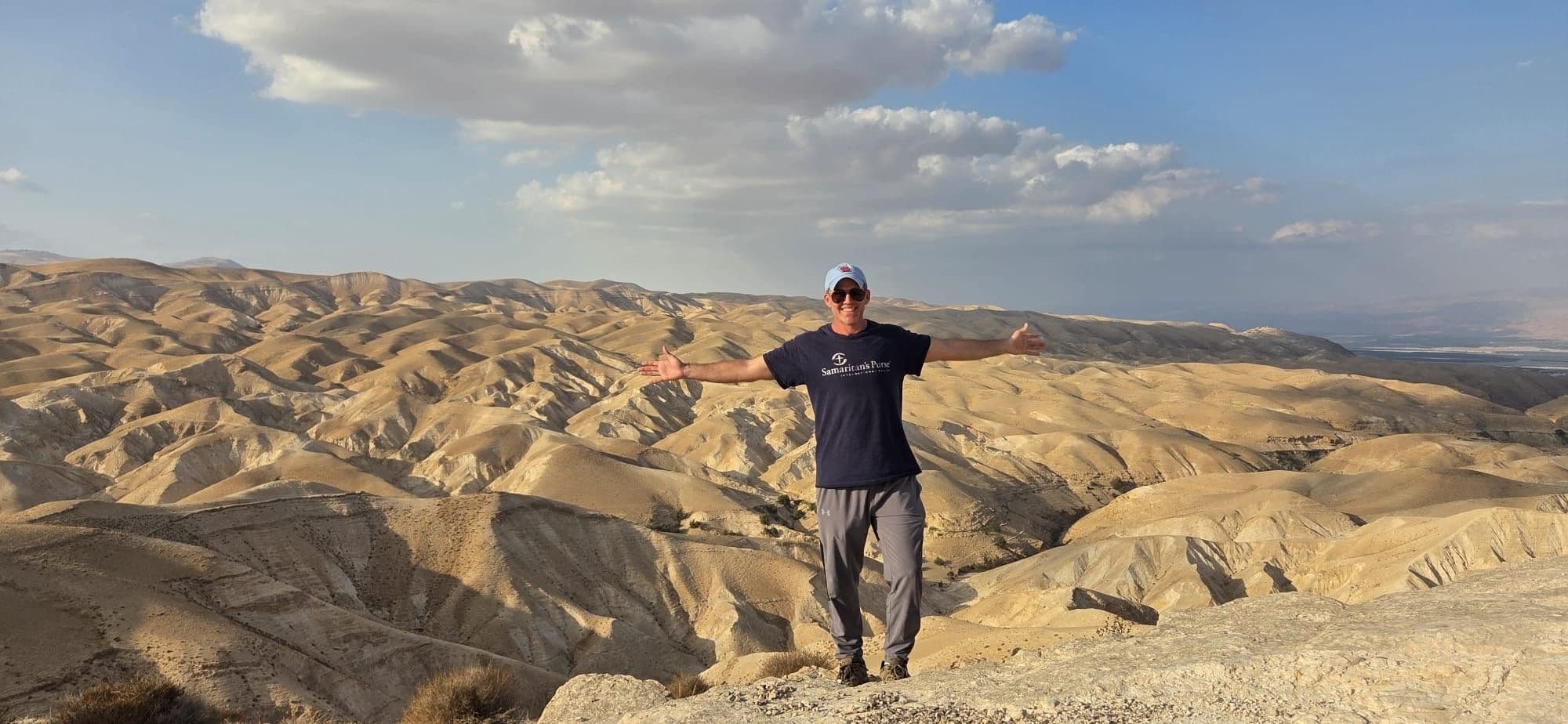A field study participant stands overlooking the Judean wilderness.